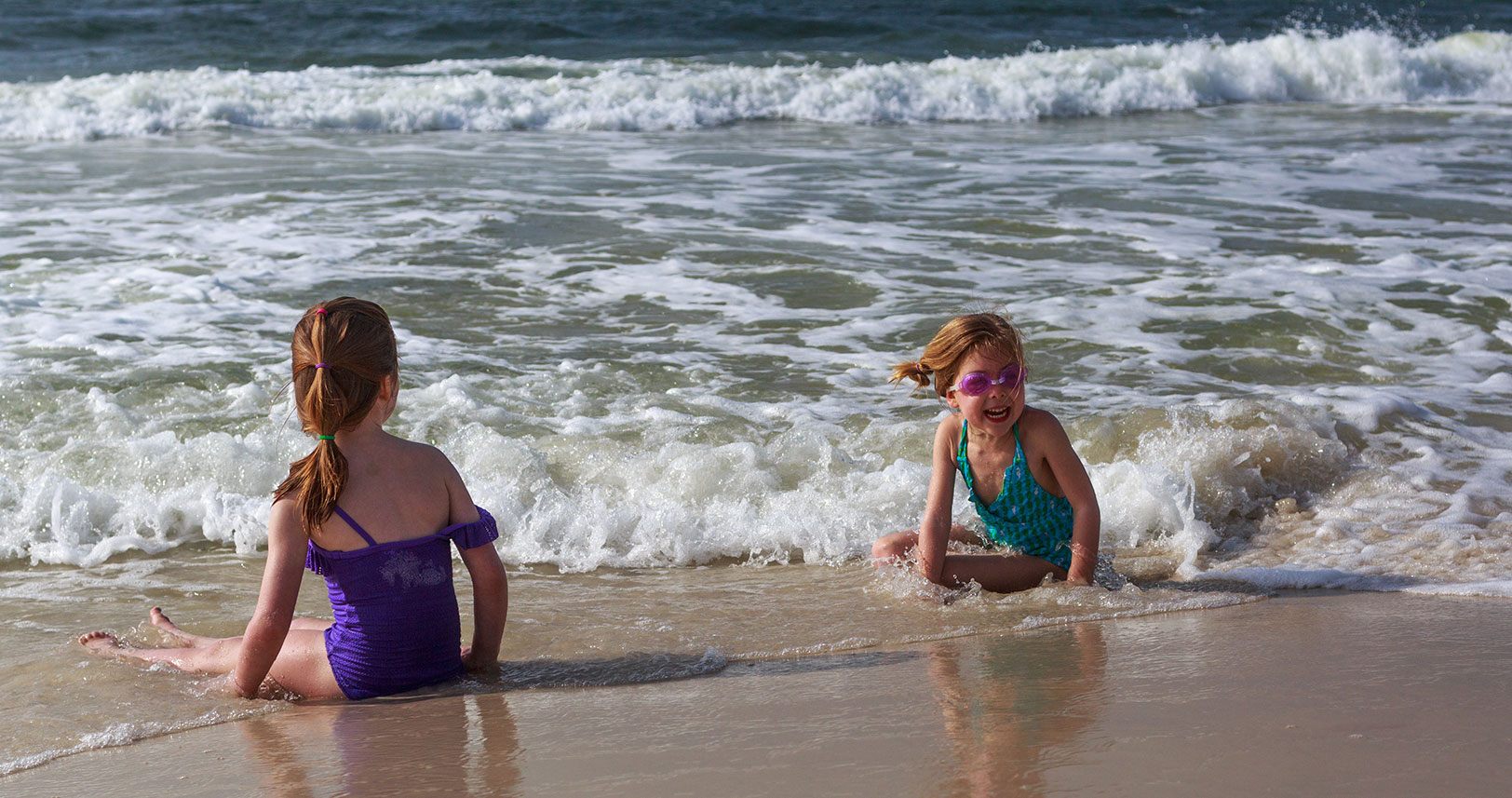 children playing in the shoreline